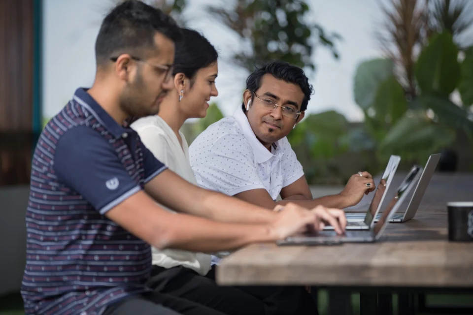 Two colleagues working together on a laptop