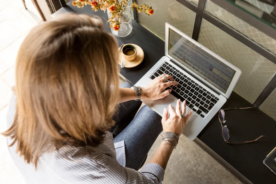 Marketer working on a laptop to manage search engine ads